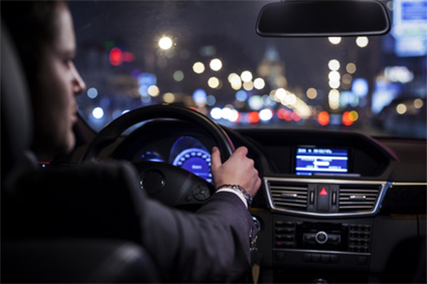 businessman driving a car at night